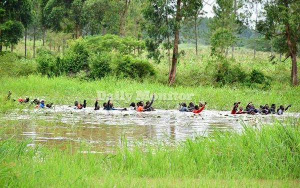 Bobi Wine supporters swimming through a swamp....Photo credit- Daily Monitor