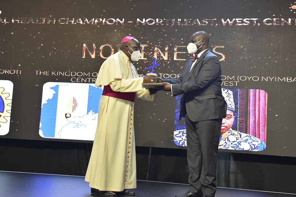 Archbishop Odama receiving his award from Deputy Speaker of Parliament Jacob Oulanyah