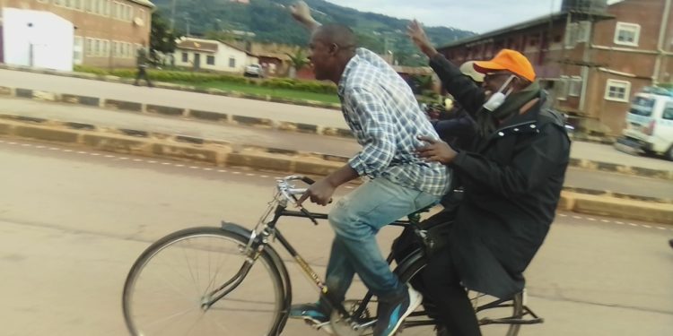 Gen Tumukunde on a bicycle