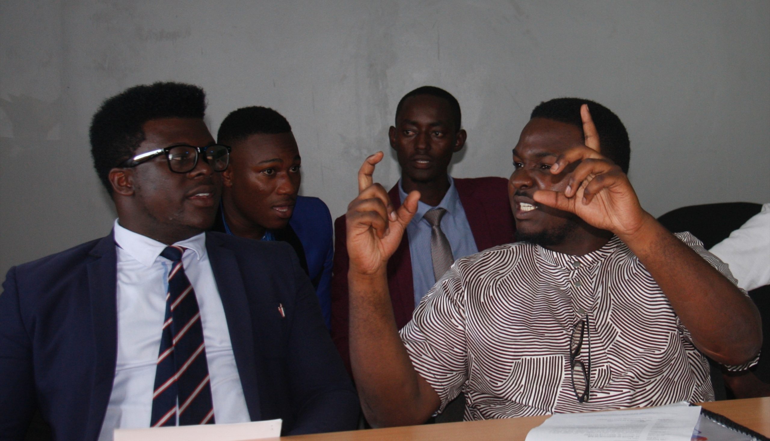 Media lab Entebbe C.E.O Ivan Walunyolo (L) observes as Spokesperson Adam Walusimbi (R) addresses the media at their offices