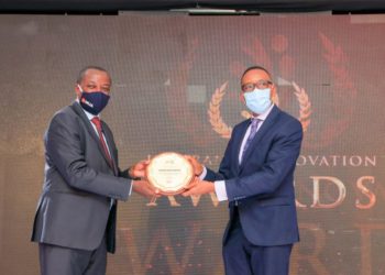 Uganda Insurers Association Chairman Latimar Mukasa hands over an award to a representative of one of the winners