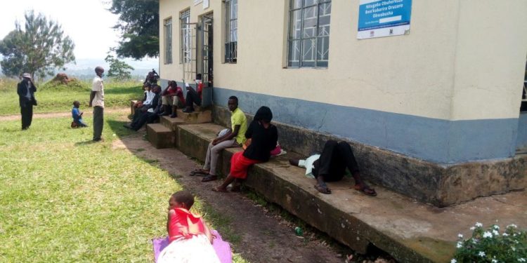 Patients waiting for health workers outside katete health center III building. photo by Ronald Kabanza.