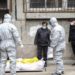 Funeral home workers remove the body of a person suspected to have died from the coronavirus outbreak from a residential building in Wuhan, Hubei Province, on February 1, 2020.   –   Copyright  Chinatopix via AP, File