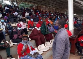 Youth claiming to belong to NUP waiting for Prime Minister Ruhakana Rugunda at Kololo Airstrip on Sunday morning