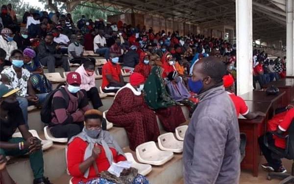 Youth claiming to belong to NUP waiting for Prime Minister Ruhakana Rugunda at Kololo Airstrip on Sunday morning