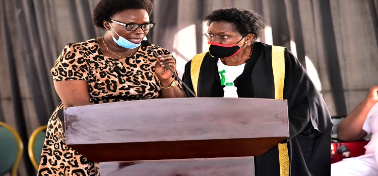The Clerk to Parliament, Jane Kibirige (R) consulting with Hon. Jane Avur during the Wednesday, 17 February 2021 plenary sitting
