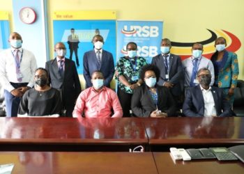 The Registrar General Mercy K.Kainobwisho (Seated 2nd R) & Tony Otoa the CEO Stanbic Business Incubator in a group photo after a meeting at the URSB Headquarters in Kampala.