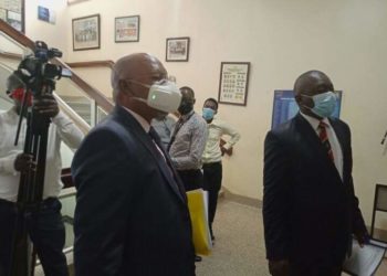 Gen Jeje Odongo putting on an expensive face mask on Tuesday