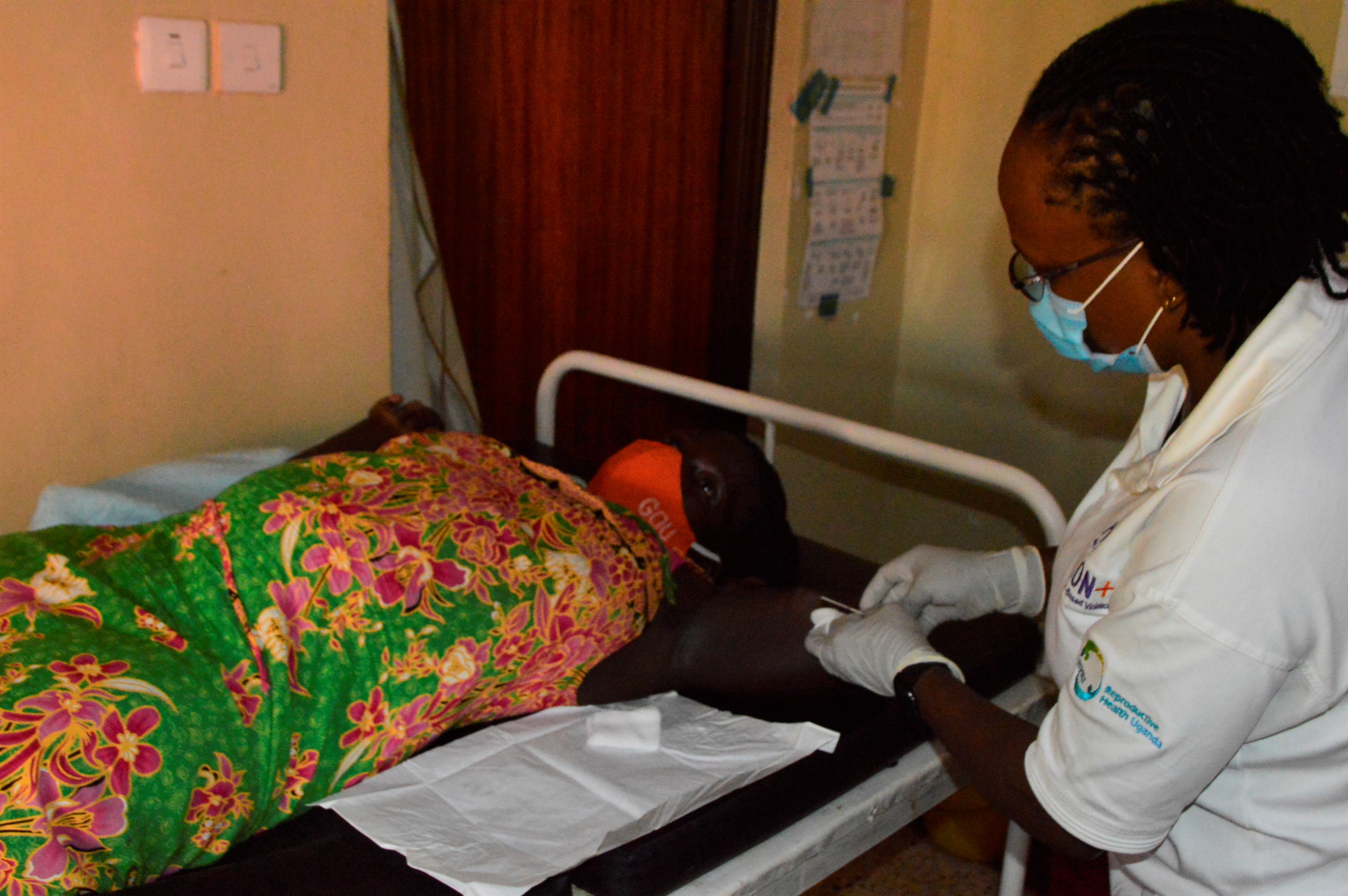 Lynda Birungi inserts a Longterm Family Planning method to Gahurabingi Annamary in Buhimba Health Centre III Kikuube district