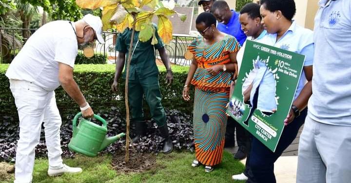 Dr Sudhir plants a tree at his home in Kololo