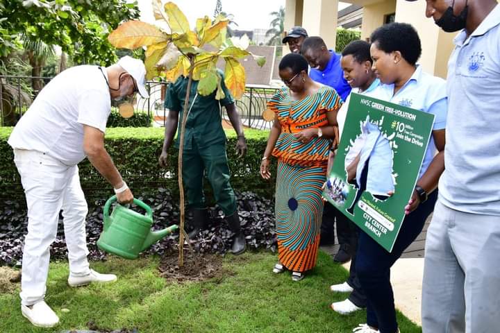 Dr Sudhir plants a tree at his home in Kololo