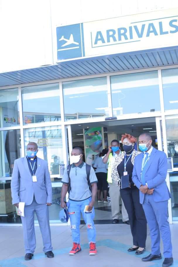 Ssekitoleko with officials from Ministry of Foreign Affairs and Ministry of Education and Sports at Entebbe Airport on Friday