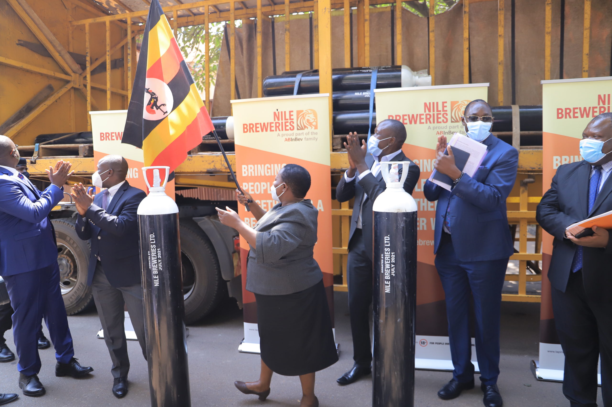Prime minister Robinah Nabbanja receiving the oxygen cylinders from Nile Breweries