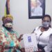 Minister Amongi (right) receives a gift pack from Elsie after the meeting