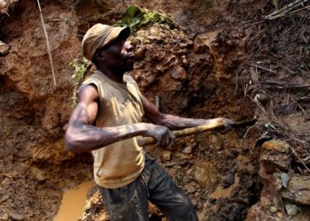 One of few remaining miners digs out soil which will later be filtered for traces of cassiterite, the major ore of tin, at Nyabibwe mine, in eastern Congo, Aug. 7, 2012.