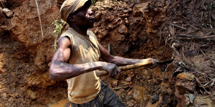 One of few remaining miners digs out soil which will later be filtered for traces of cassiterite, the major ore of tin, at Nyabibwe mine, in eastern Congo, Aug. 7, 2012.