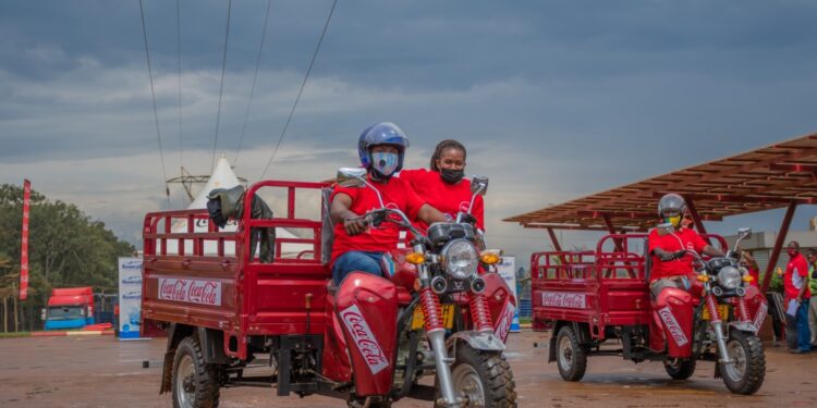 Winners test driving the Tuk-Tuks at Coca-Cola Namanve