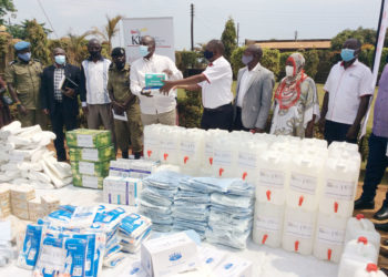 Kalangala Infrastructure Services (KIS) Marketing and Public Relations Manager Mr Joseph Mulindwa (4th right) hands over a donation of assorted infection prevention and control materials worth Shs32 million to the Chairman District Covid-19 Task Committee and RDC Kalangala, Mr Apollo Mugume recently