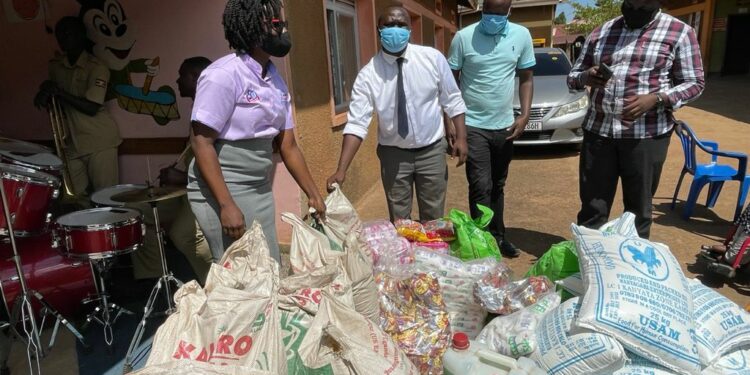 Pablo Bashir (white shirt) celebrates birthday with children with disabilities by donating items worth millions of shillings.