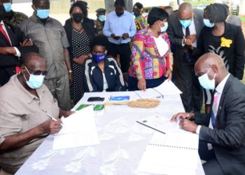 Gen Salim Saleh (Left) the Chief Coordinator of Operation Wealth Creation (OWC) and Mr Alvin Mbugua the Executive Director UBL signing the MoU