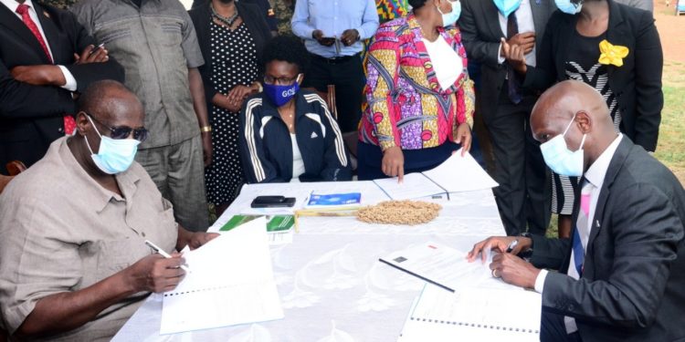 Gen Salim Saleh (Left) the Chief Coordinator of Operation Wealth Creation (OWC) and Mr Alvin Mbugua the Executive Director UBL signing the MoU