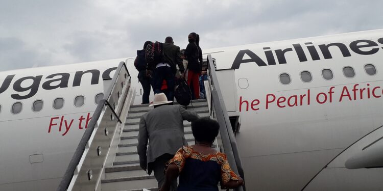 Passengers boarding Uganda Airlines Airbus