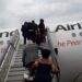 Passengers boarding Uganda Airlines Airbus