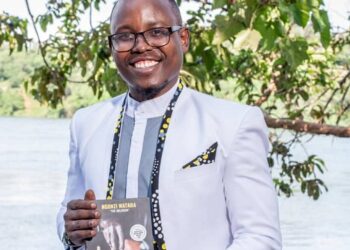 Growth Coach Ngonzi Wataba posing with his recently published book