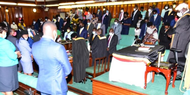 MPs bowing in prayer shortly before commencing deliberations.