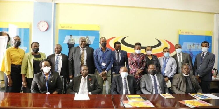 (L-R) Registrar General, Mercy K. Kainobwisho, Board Chair, Amb. Francis K. Butagira in a group picture with Board Members & Staff after the Launch of the Trademark Filing System.