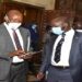 State Minister for Finance, Hon Lugoloobi(L) with Hon Ssekikubo after adjournment of the plenary sitting