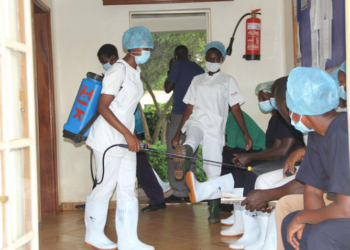 Health workers sanitizing before treating Covid-19 patients