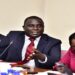 Muwanga Kivumbi (C) makes his presentation before the Budget Committee