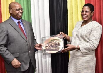 The Deputy Speaker of Parliament, Anita Among, shares a light moment with Zimbabwean Parliament Speaker, Jacob Francis Nzwidamililo Mudenda.