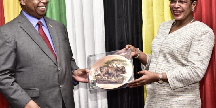 The Deputy Speaker of Parliament, Anita Among, shares a light moment with Zimbabwean Parliament Speaker, Jacob Francis Nzwidamililo Mudenda.