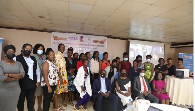 (L-R) Gilbert Agaba, Director Intellectual Property URSB, Caroline Egesa, Board Secretary URSB, James Wasula GSWIM Chairman & Lillian Nantume CEO pose for a group photo with the participants during the workshop at Hotel Africana in Kampala.