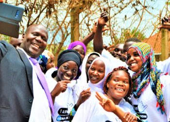 Jackson Chekweko RHU ED with children in Kamuli district