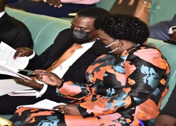 Gender Minister, Hon Betty Amongi (C) consults the Attorney General, Hon Kiryowa Kiwanuka as debate on the bill goes. On her left is the Committee Chairperson, Hon Kabahenda