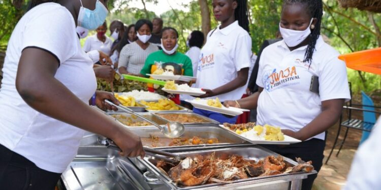 Invited guests being served delicious fish dishes