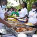 Invited guests being served delicious fish dishes