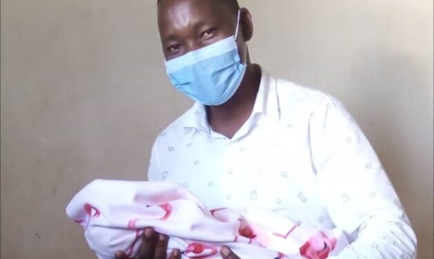 Lira Deputy RCC Paul Eseru carrying his newly born baby