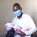 Lira Deputy RCC Paul Eseru carrying his newly born baby