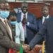 Dr. Patrick Mugoya, left, shakes hands with Garang Majak, first undersecretary at the Ministry of Finance in Juba on Monday, October 5, 2020