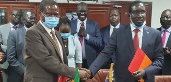Dr. Patrick Mugoya, left, shakes hands with Garang Majak, first undersecretary at the Ministry of Finance in Juba on Monday, October 5, 2020