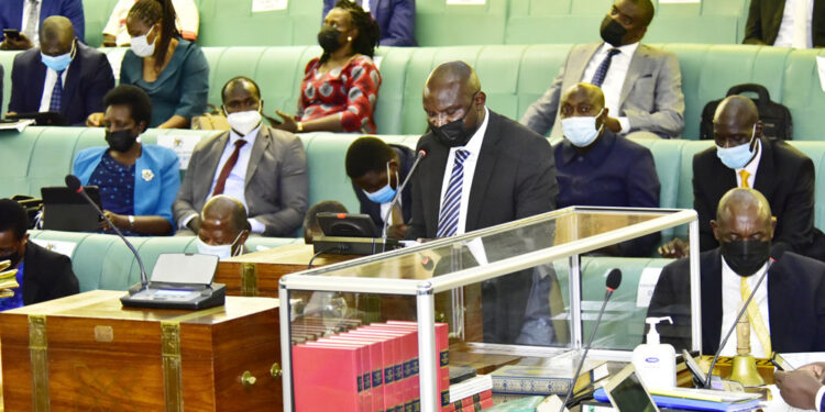 The Chairperson Committee on National Economy, Ikojo John Bosco, presenting the report.