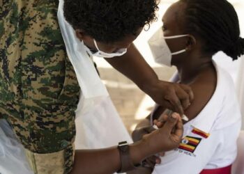 A nurse receiving her Covid-19 vaccine jab