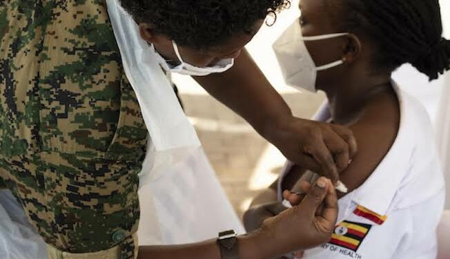 A nurse receiving her Covid-19 vaccine jab