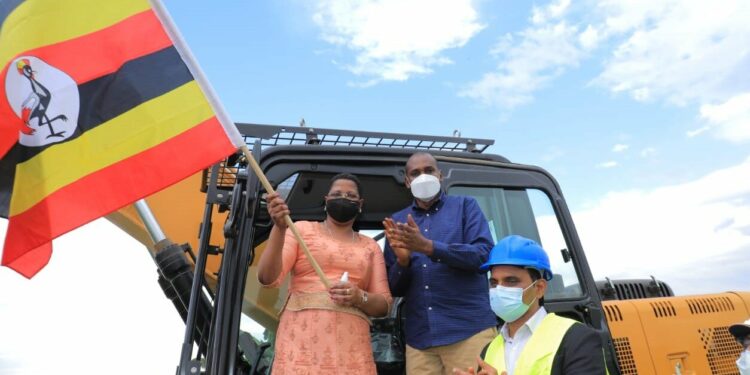 The Deputy Speaker, Anita Among, flagging off construction of Acomai irrigation scheme. Looking on is the Minister of Agriculture, Frank Tumwebaze and the contractor, Dott Services