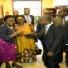 Nankabirwa and Tayebwa, accompanied by colleagues, fist bump to celebrate the passing of the EACOP Bill