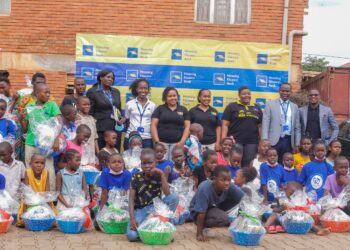 Housing Finance Bank team pose with CRANE children after handing over the hampers